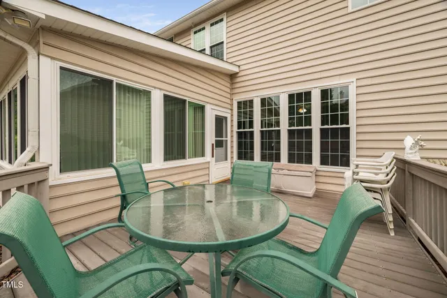 a view of a house with a chairs in patio