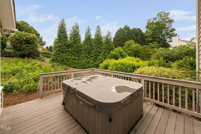 a view of a balcony with wooden floor and fence