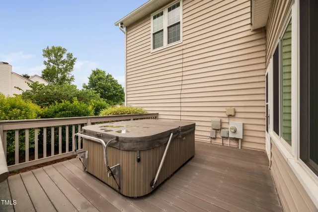 a view of balcony with wooden floor and seating space
