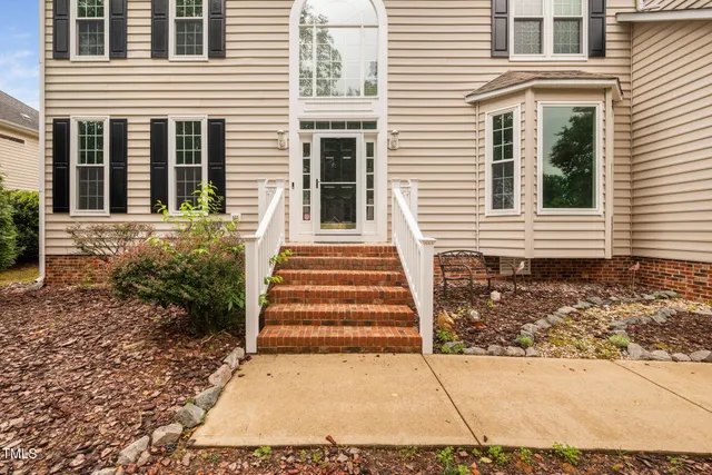 a view of a house with more windows and brick walls