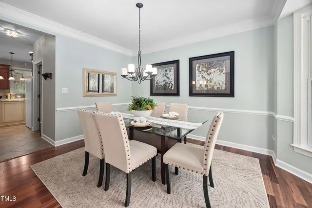 a view of a dining room with furniture wooden floor and a chandelier