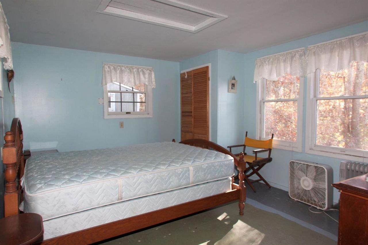 11 Hamblin Road Mashpee, MA 02649 - Photo 11 of 18 a bed sitting in a bedroom next to a window