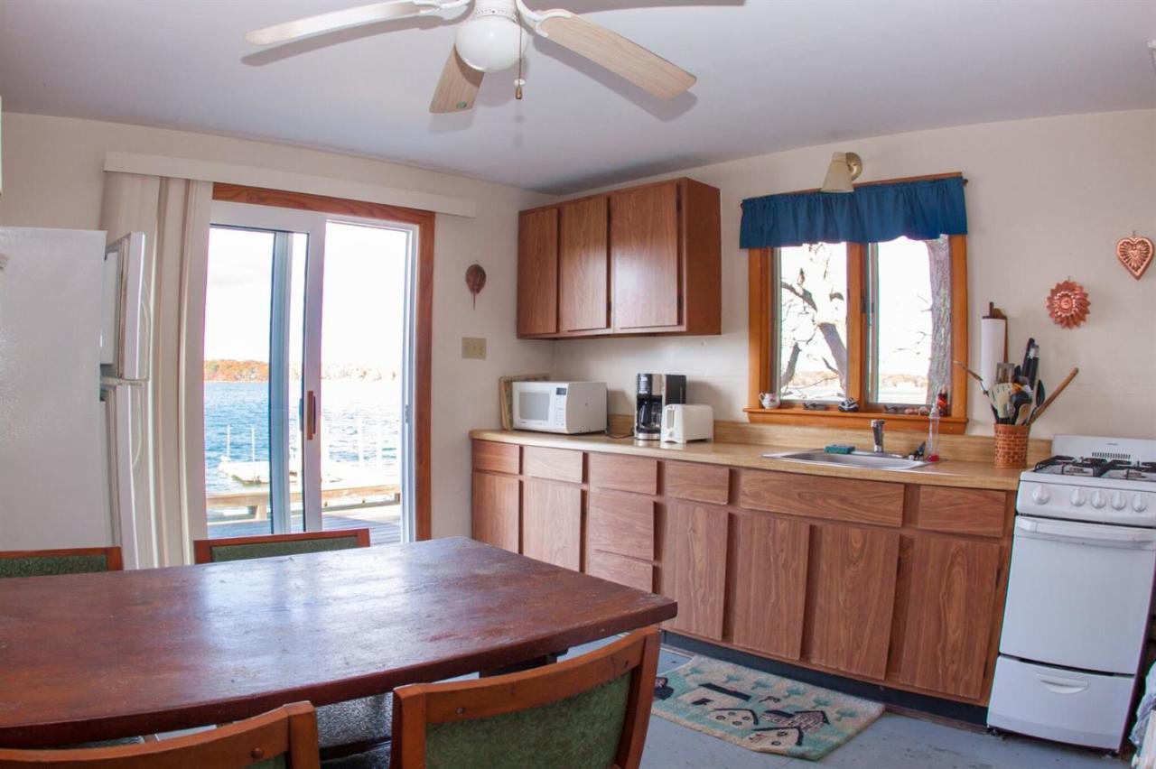 11 Hamblin Road Mashpee, MA 02649 - Photo 7 of 18 a kitchen with stainless steel appliances granite countertop a stove a sink dishwasher and microwave with wooden floor
