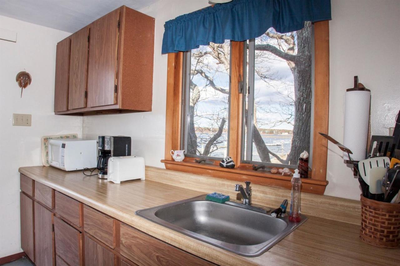 11 Hamblin Road Mashpee, MA 02649 - Photo 8 of 18 a kitchen with granite countertop a sink and a window