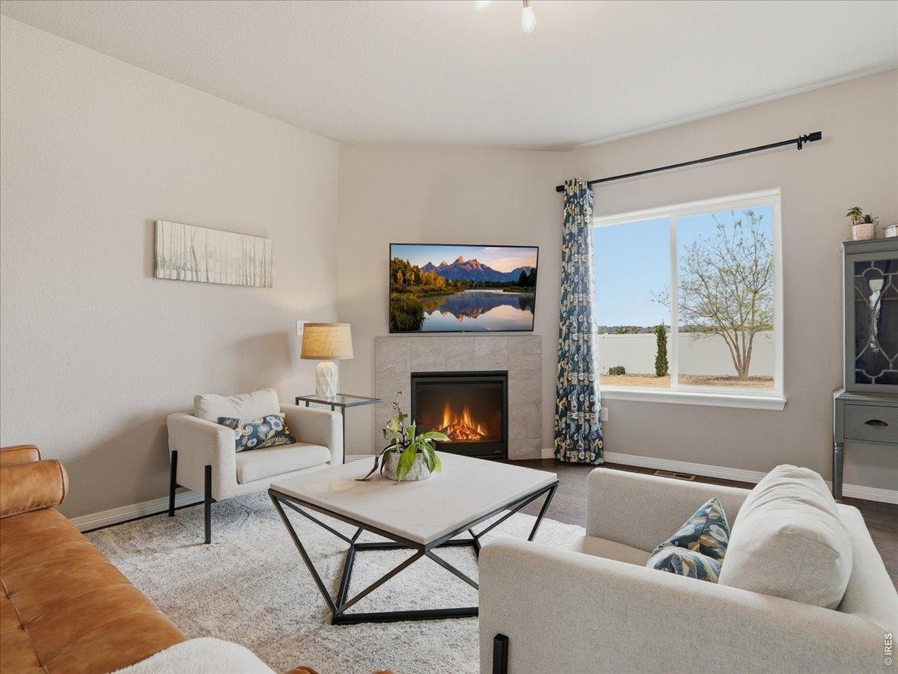 1766 Ruddlesway Drive Windsor, CO 80550 - Photo 3 of 50 a living room with furniture and a fireplace