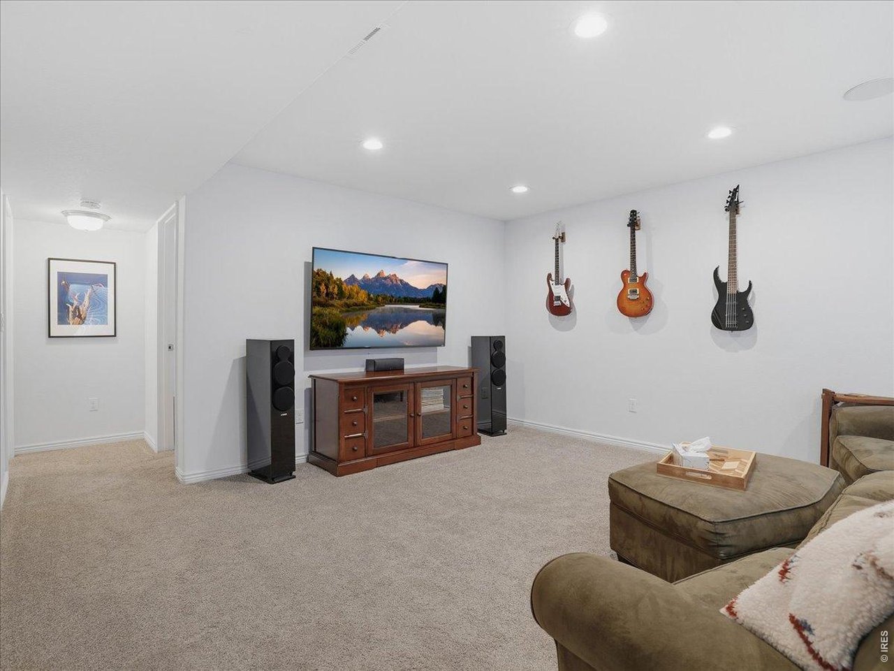 1766 Ruddlesway Drive Windsor, CO 80550 - Photo 33 of 50 a living room with furniture and a flat screen tv