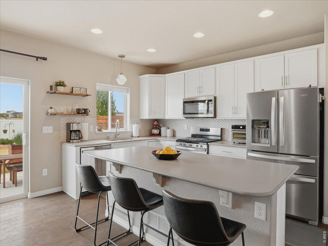 1766 Ruddlesway Drive Windsor, CO 80550 - Photo 4 of 50 Beautiful White Kitchen With Upgraded Tile Backsplash