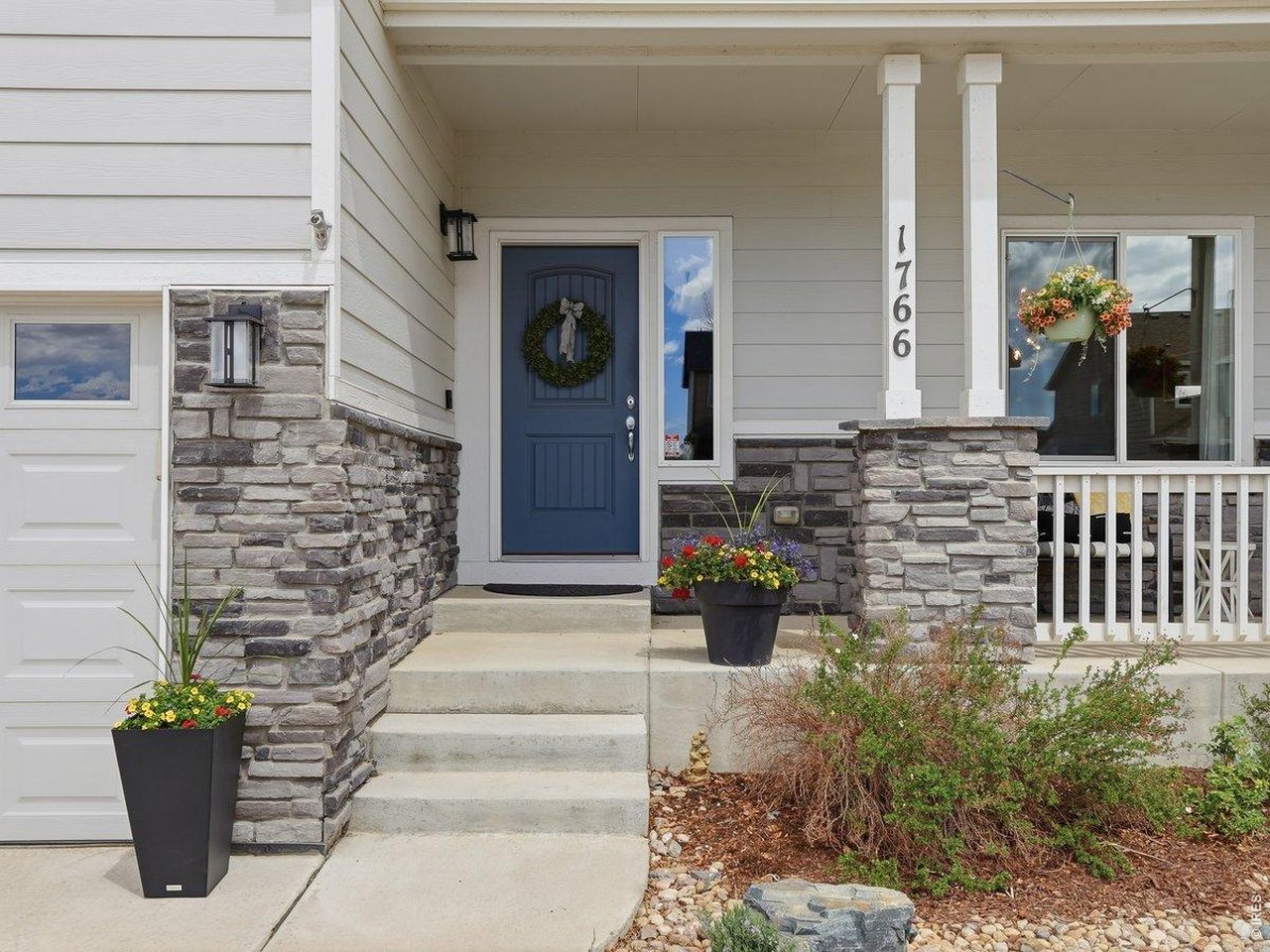 1766 Ruddlesway Drive Windsor, CO 80550 - Photo 45 of 50 a view of front door of house with potted plant