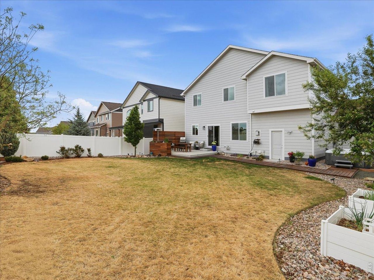 1766 Ruddlesway Drive Windsor, CO 80550 - Photo 47 of 50 a front view of house with yard and trees in the background