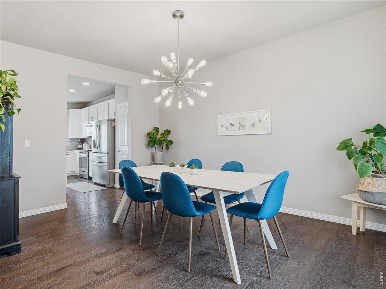 1766 Ruddlesway Drive Windsor, CO 80550 - Photo 6 of 50 a view of a dining room with furniture and wooden floor