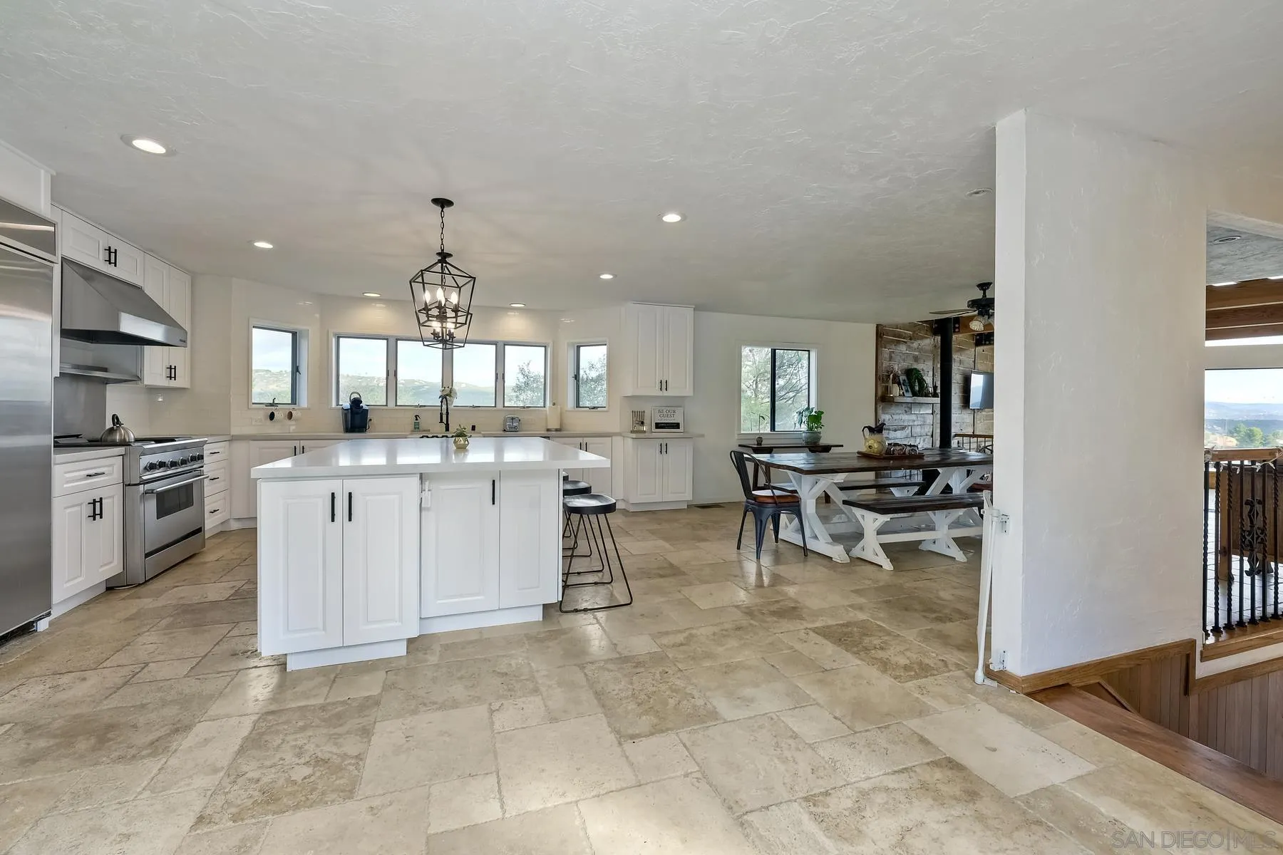 20570 Sycamore Springs Road Jamul, CA 91935 - Photo 11 of 39 a large white kitchen with white cabinets and a stove