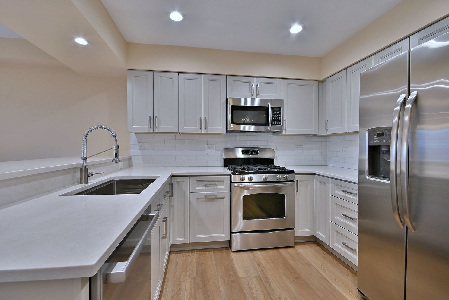 3208 Raphael Court St. Charles, IL 60175 - Photo 16 of 47 a kitchen with kitchen island stainless steel appliances a sink stove top oven and refrigerator