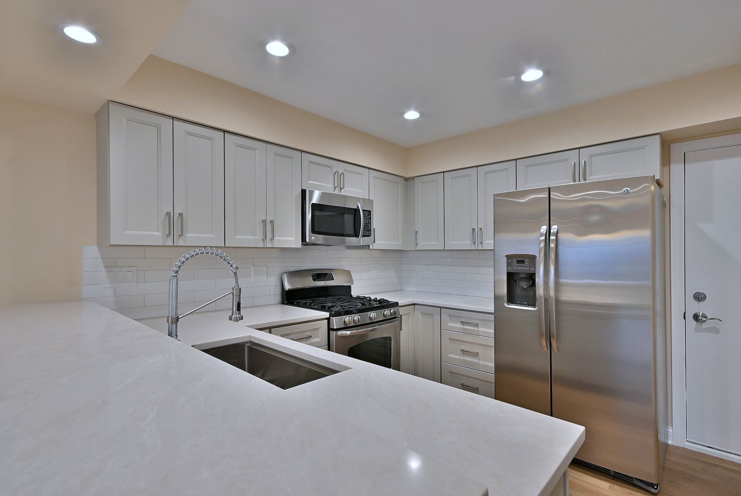 3208 Raphael Court St. Charles, IL 60175 - Photo 19 of 47 a kitchen with a sink a refrigerator and cabinets