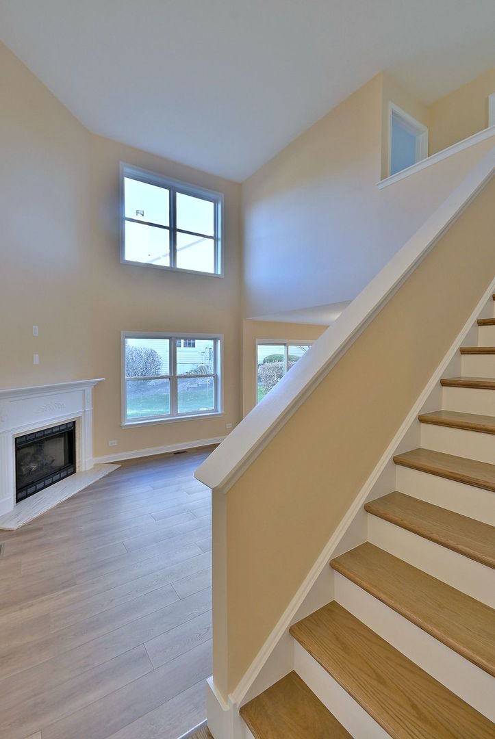 3208 Raphael Court St. Charles, IL 60175 - Photo 29 of 47 a view of staircase and fireplace