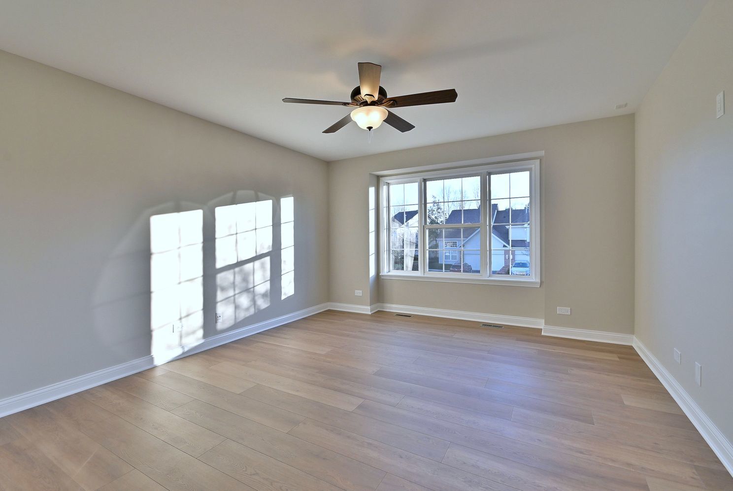 3208 Raphael Court St. Charles, IL 60175 - Photo 33 of 47 an empty room with wooden floor chandelier fan and windows