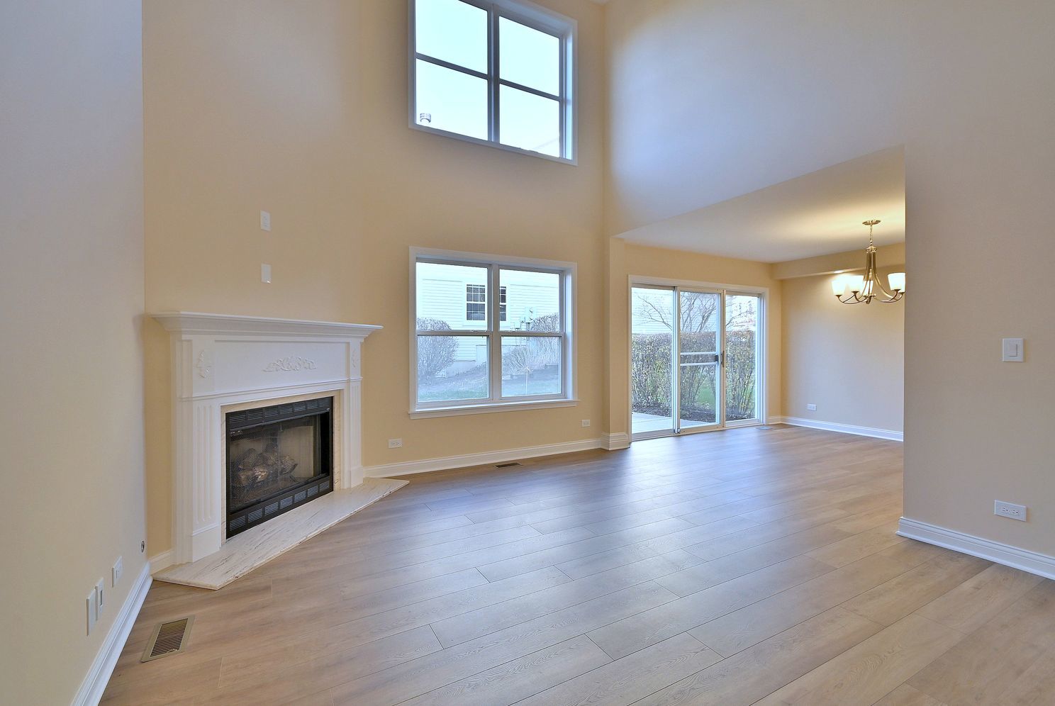3208 Raphael Court St. Charles, IL 60175 - Photo 7 of 47 wooden floor fireplace and windows in an empty room