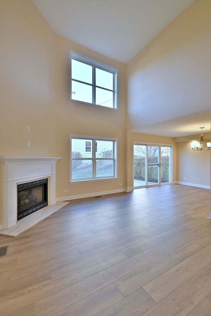 3208 Raphael Court St. Charles, IL 60175 - Photo 8 of 47 an empty room with windows and fireplace