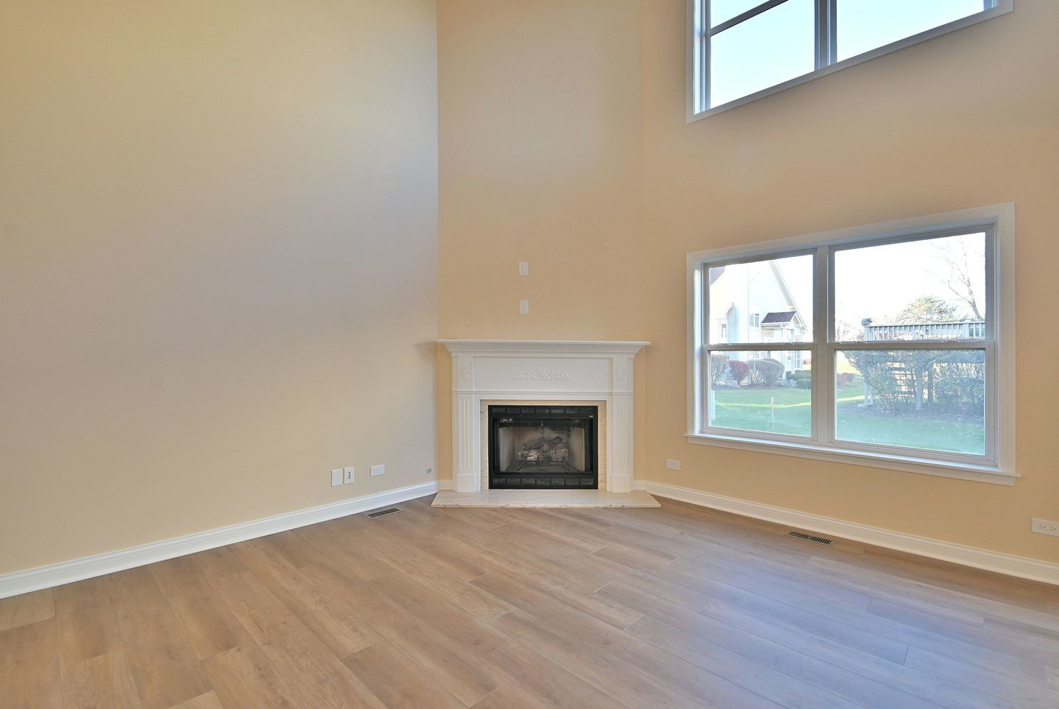 3208 Raphael Court St. Charles, IL 60175 - Photo 10 of 47 an empty room with wooden floor fireplace and windows