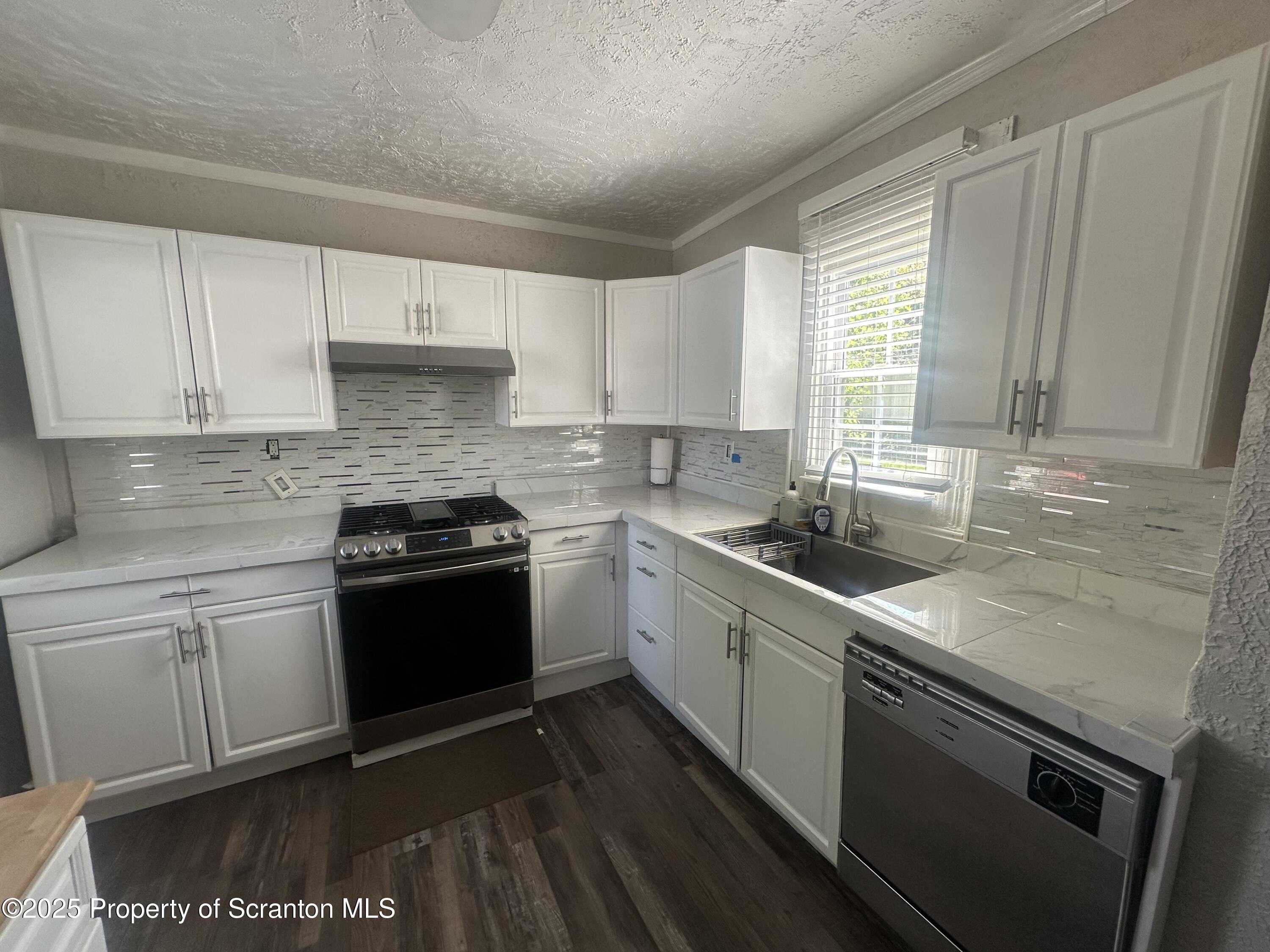 821 Maple Street Scranton, PA 18505 - Photo 7 of 21 a kitchen with a sink stove top oven and cabinets
