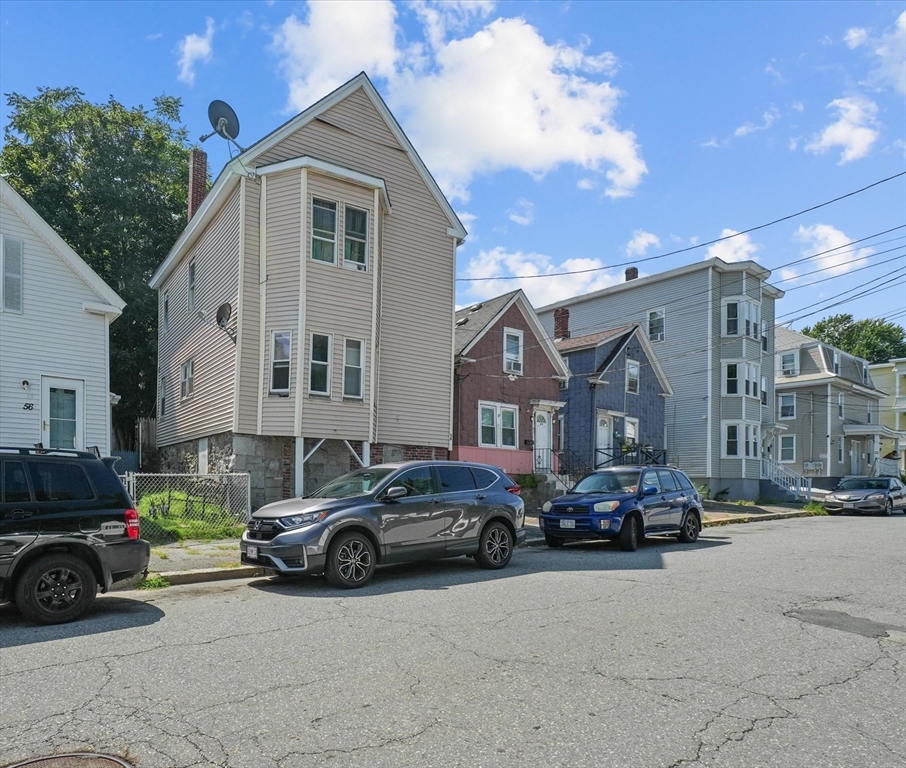 58-64 Railroad Street Lawrence, MA 01841 - Photo 2 of 9 a car parked in front of a house