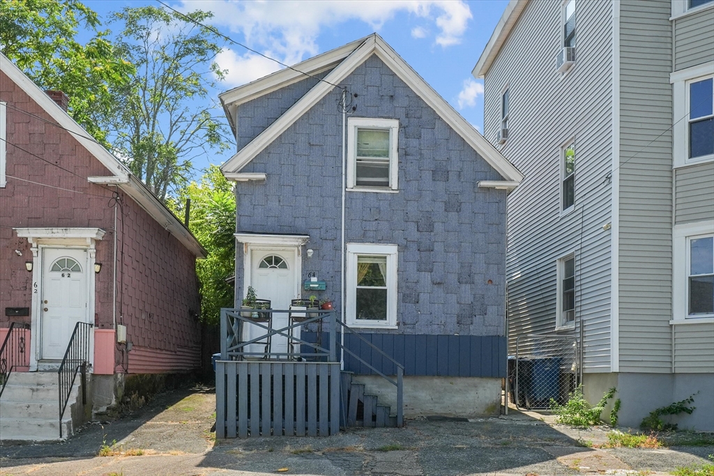 58-64 Railroad Street Lawrence, MA 01841 - Photo 3 of 9 a front view of a house with garage