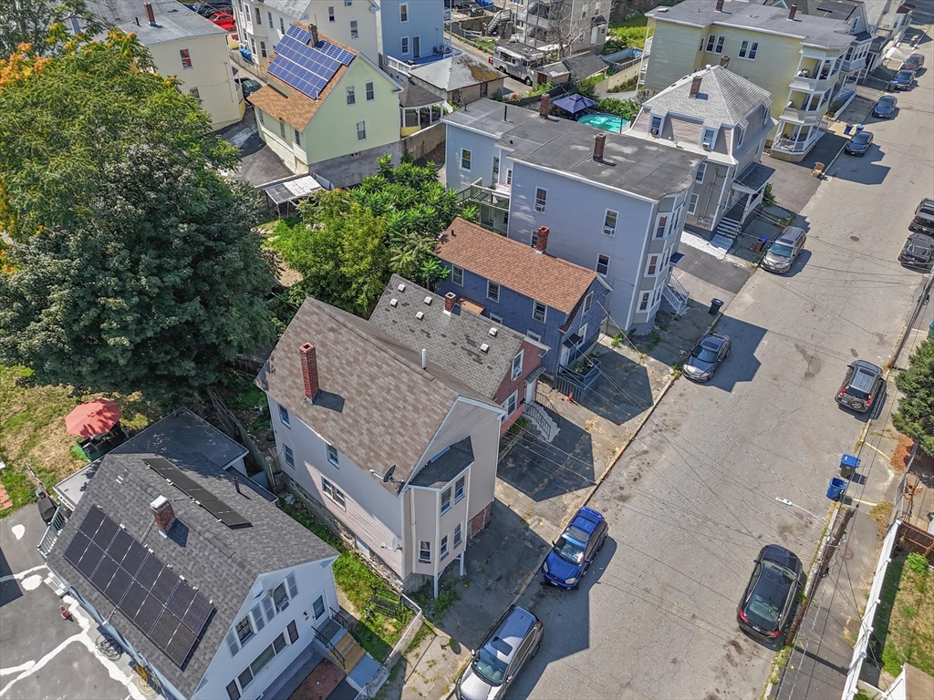 58-64 Railroad Street Lawrence, MA 01841 - Photo 7 of 9 an aerial view of a house with a yard
