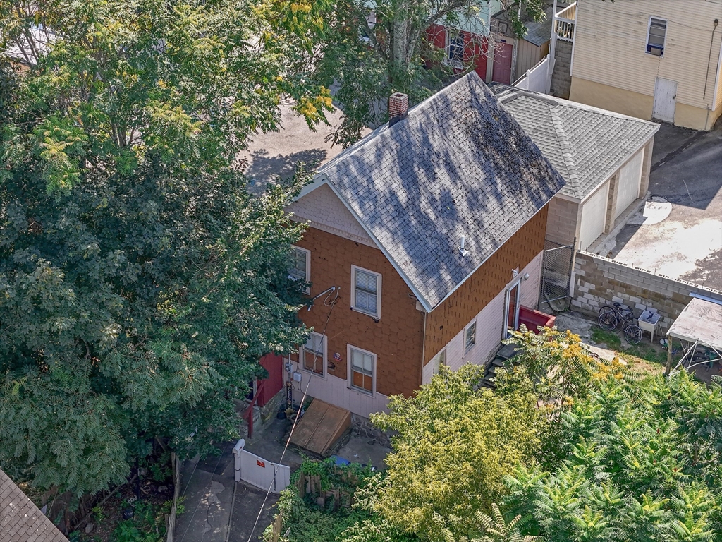 58-64 Railroad Street Lawrence, MA 01841 - Photo 8 of 9 a backyard of a house with lots of green space