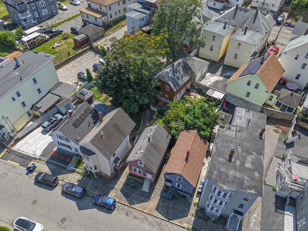 58-64 Railroad Street Lawrence, MA 01841 - Photo 9 of 9 an aerial view of a house with a yard and lake view