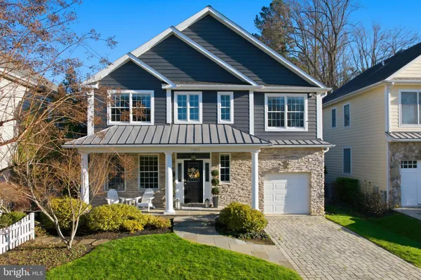 a front view of a house with garden and porch