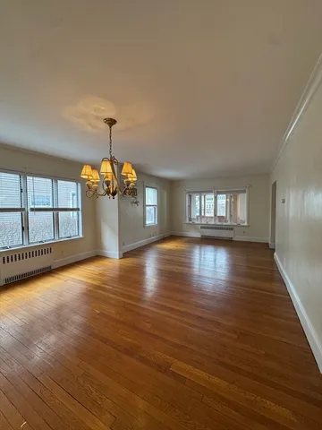 a view of room with window and wooden floor
