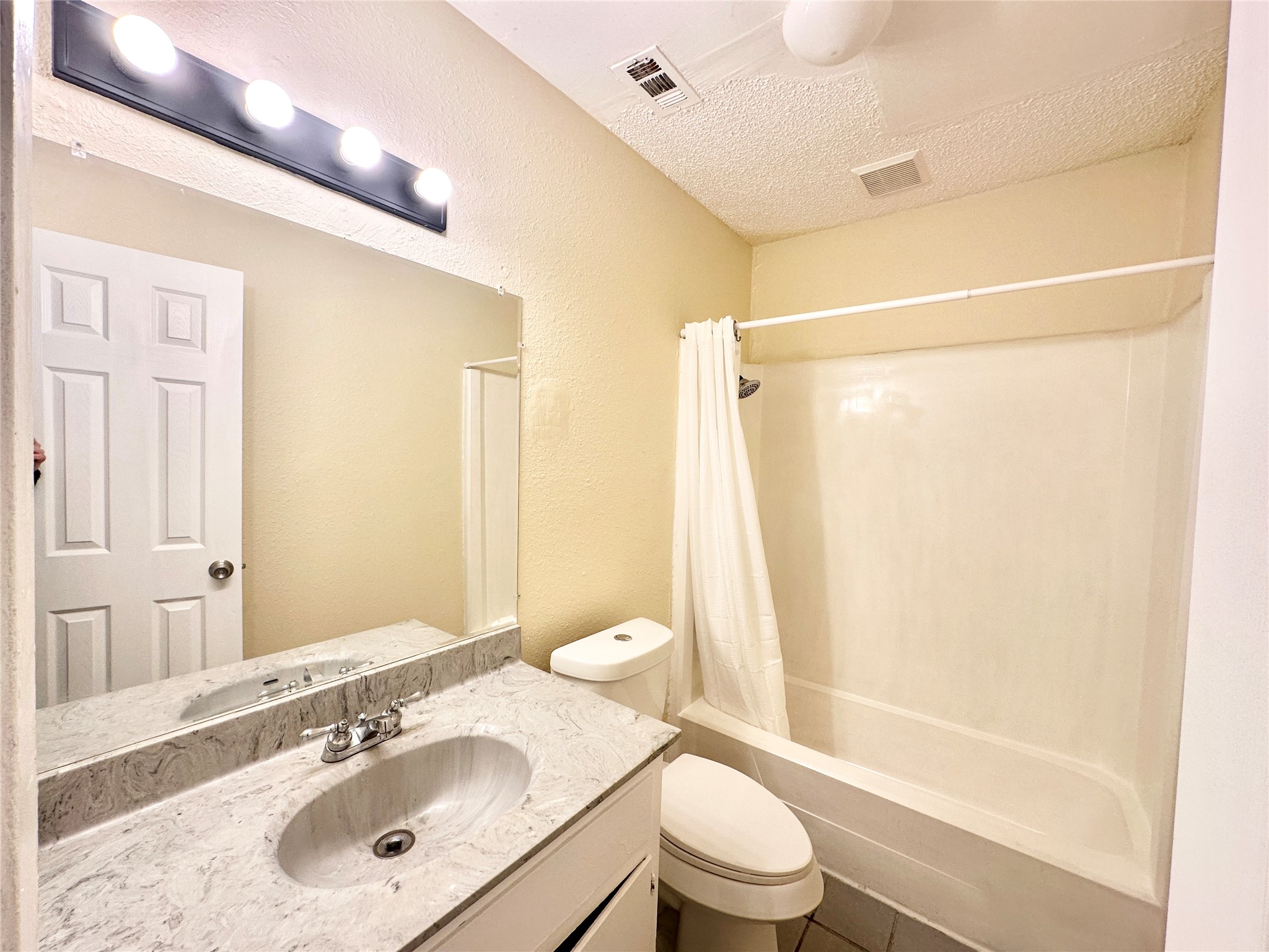 4302 Scottsdale Road, Unit A Austin, TX 78721 - Photo 15 of 30 a bathroom with a sink mirror toilet and bathtub