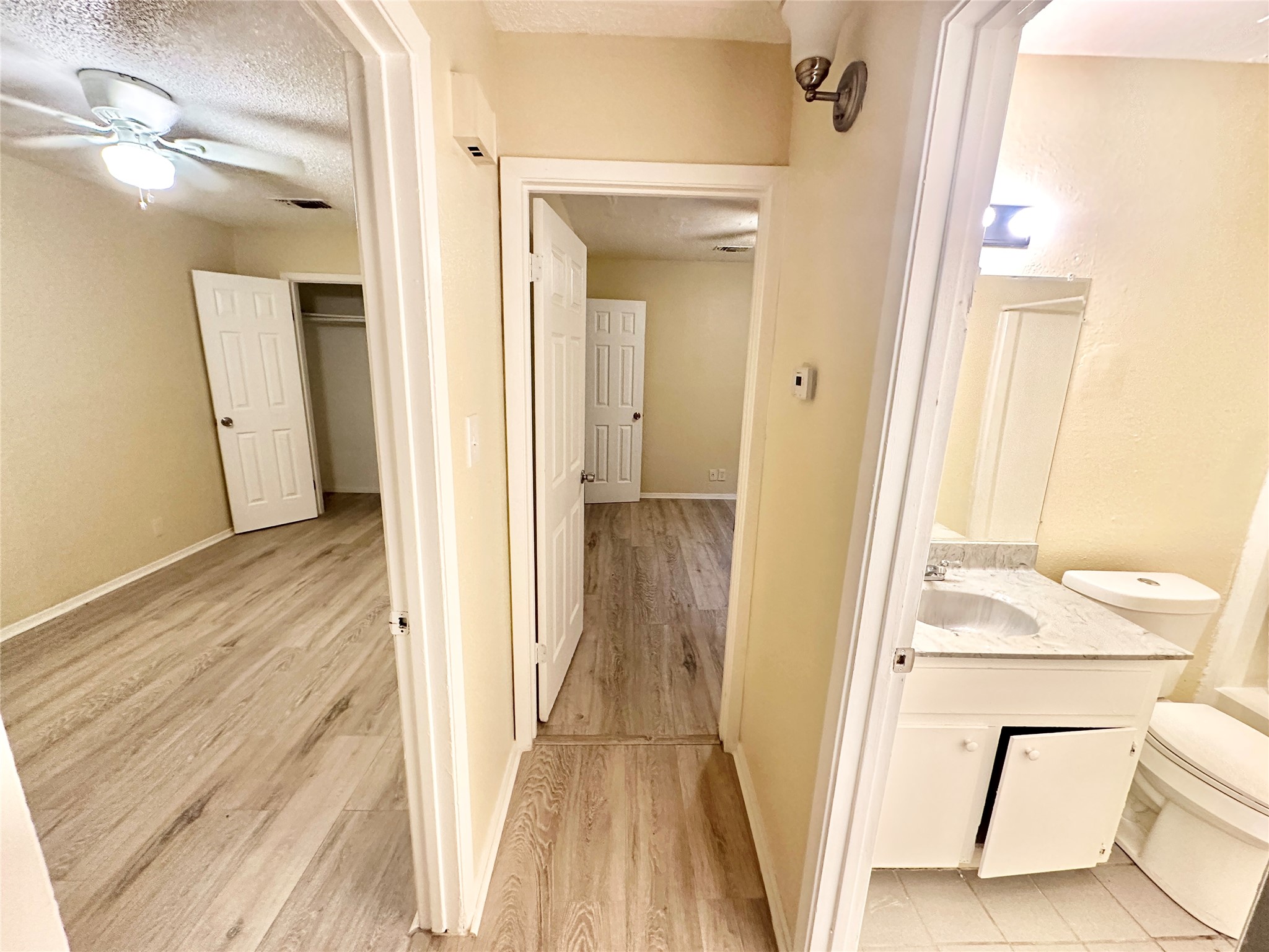 4302 Scottsdale Road, Unit A Austin, TX 78721 - Photo 16 of 30 a view of a hallway with wooden floor and staircase