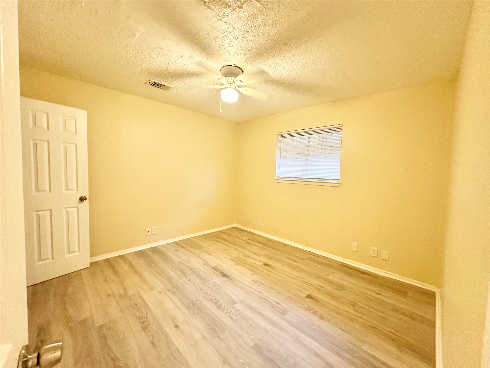 4302 Scottsdale Road, Unit A Austin, TX 78721 - Photo 22 of 30 a view of an empty room with wooden floor and a window