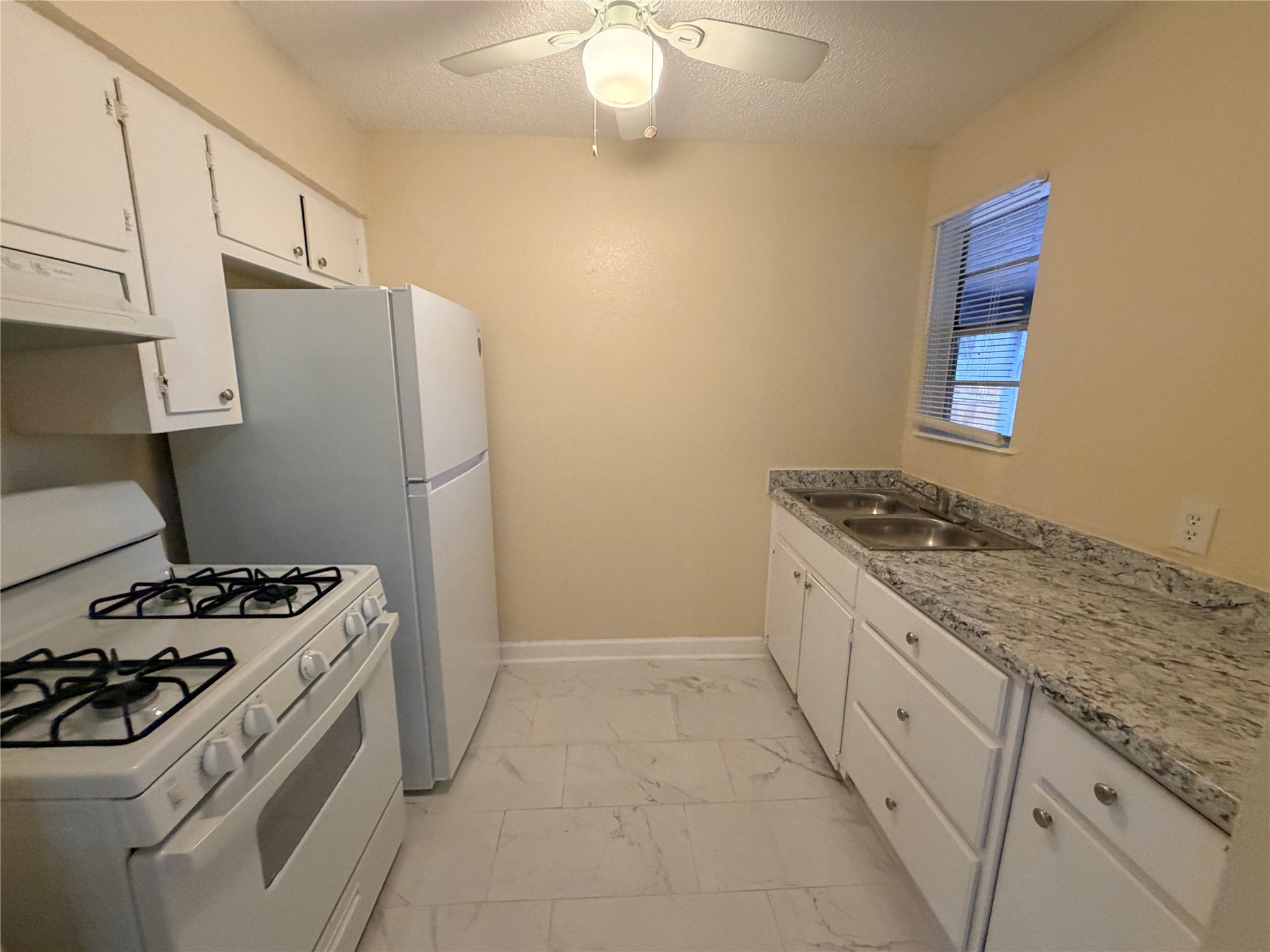 4302 Scottsdale Road, Unit A Austin, TX 78721 - Photo 9 of 30 a kitchen with a stove and a refrigerator