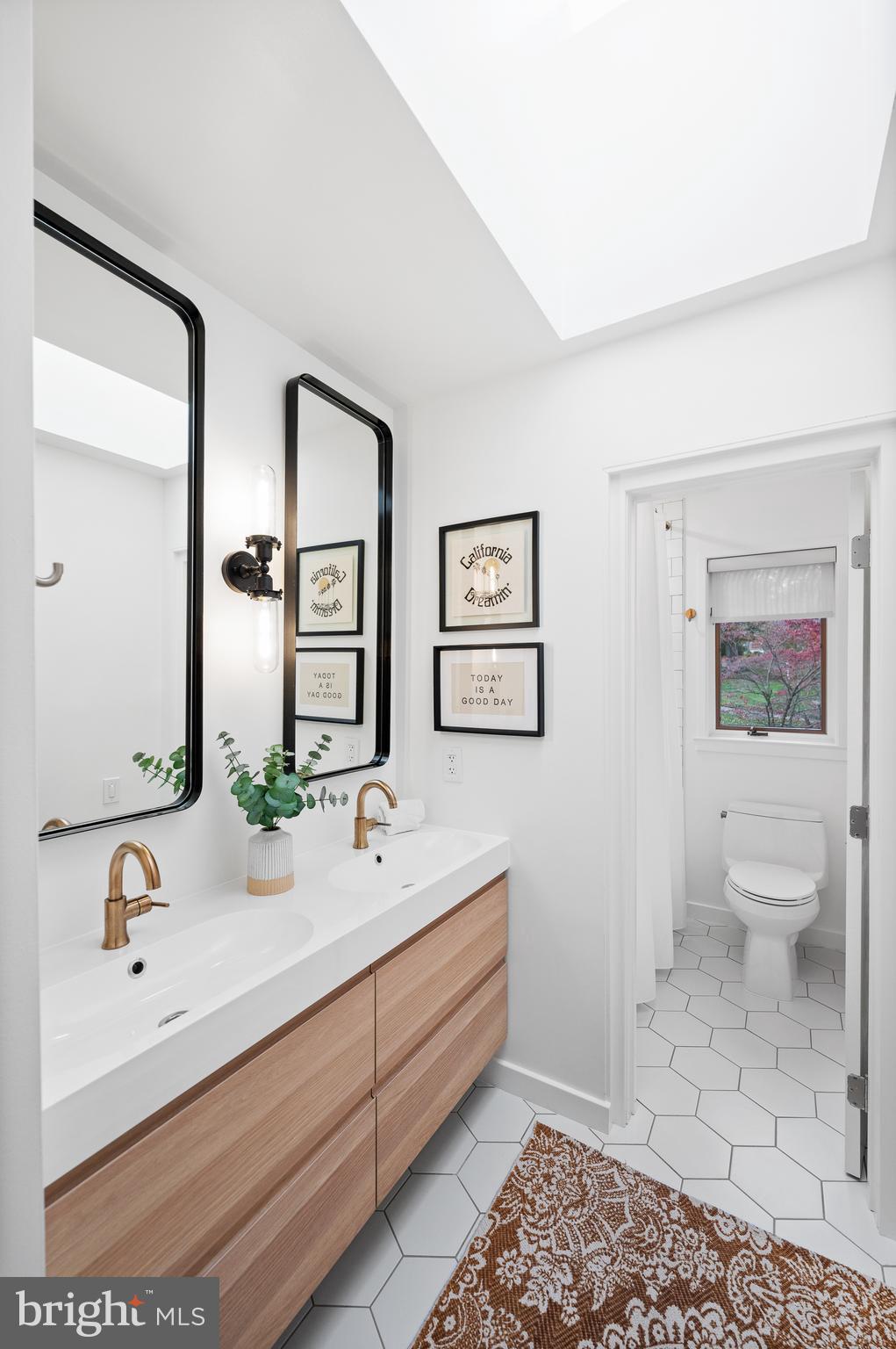 309 Valley Place Radnor, PA 19087 - Photo 20 of 29 a bathroom with a sink a toilet and mirror
