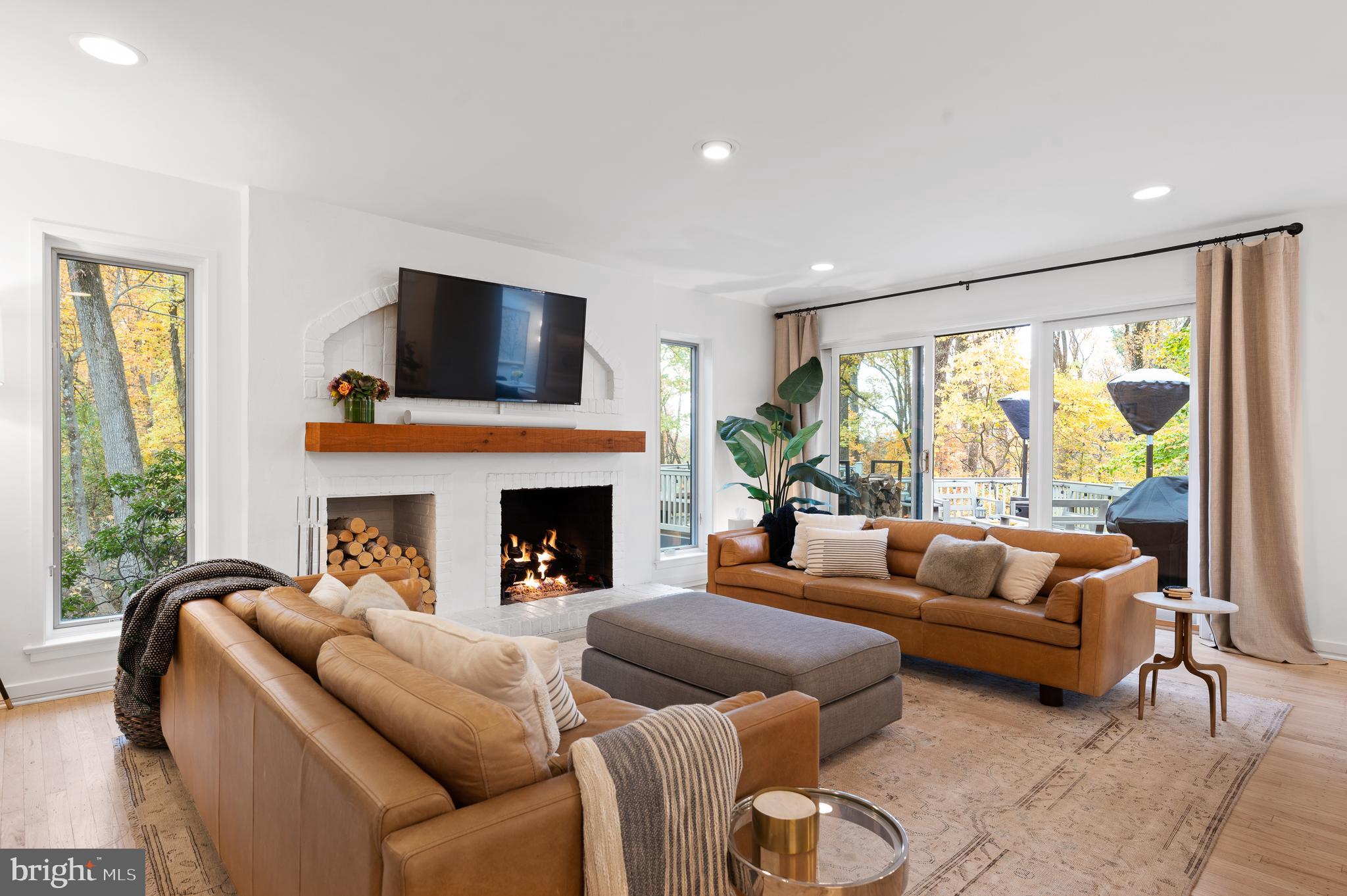309 Valley Place Radnor, PA 19087 - Photo 9 of 29 a living room with furniture a fireplace and a large window