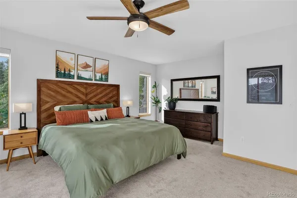 a bedroom with a bed and a chandelier