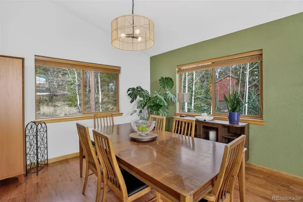 a view of a dining room with furniture window and wooden floor