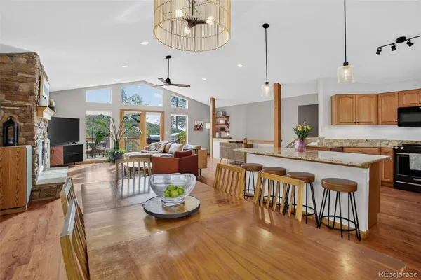 an open kitchen with dining table and chairs