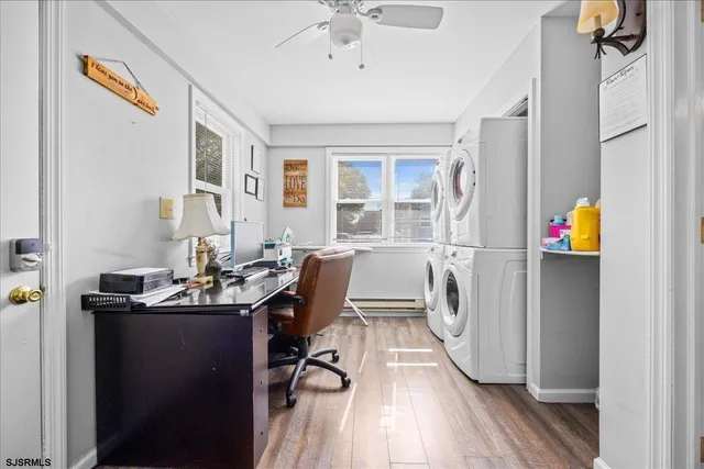a view of a workspace with furniture and a window