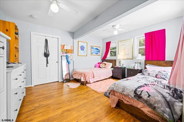 a view of a bedroom with bed and window