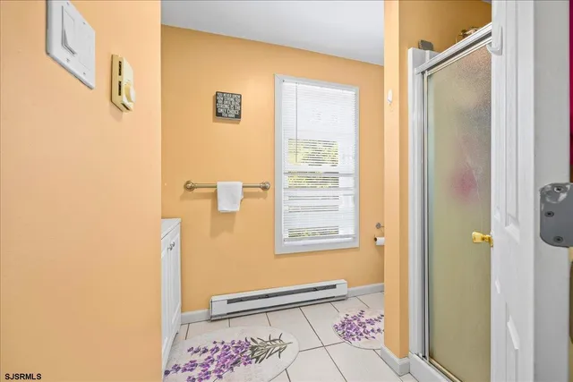 a bathroom with a window and a shower