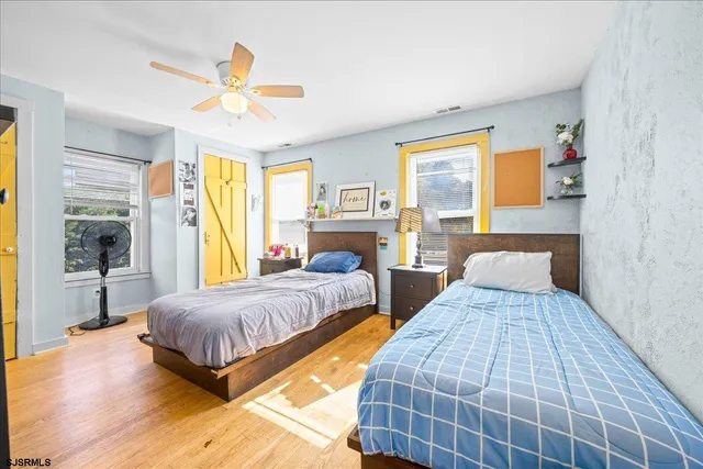 a bedroom with double bed and a large window