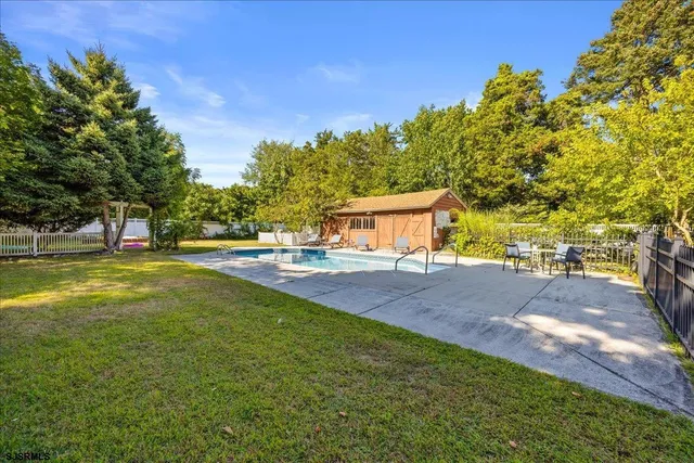 a view of green field with tree in the background
