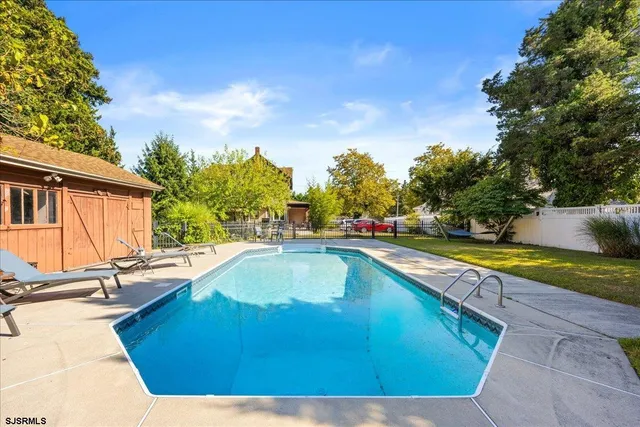 a view of a swimming pool with a yard
