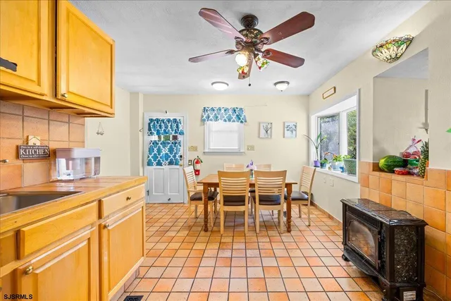 a view of a dining room with furniture a chandelier and wooden floor