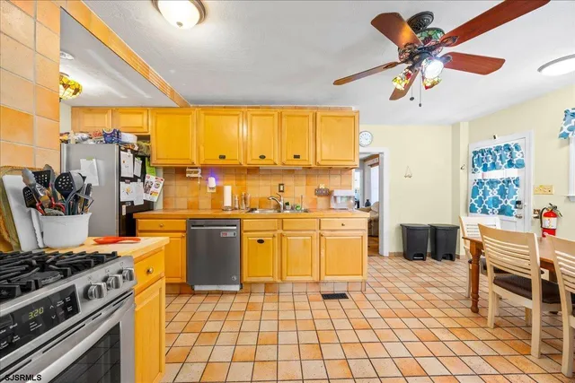 a kitchen with a stove a sink and a refrigerator