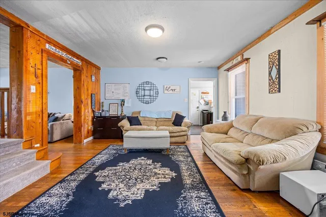 a living room with furniture rug and wooden floor