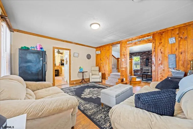 a living room with furniture and large windows