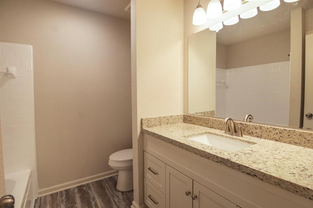 4615 Roserock Lane Spring, TX 77388 - Photo 13 of 21 a bathroom with a granite countertop sink a toilet and a mirror